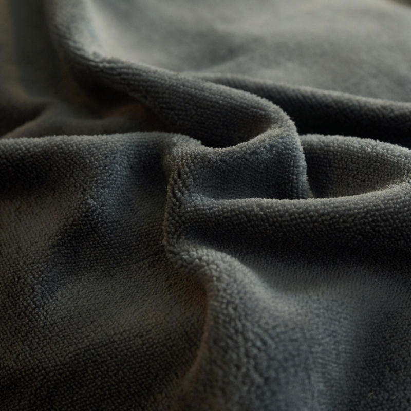 Textuur van grijs pluche stof close-up